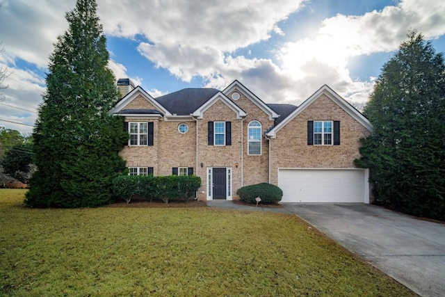 view of front of property featuring a garage and a front lawn