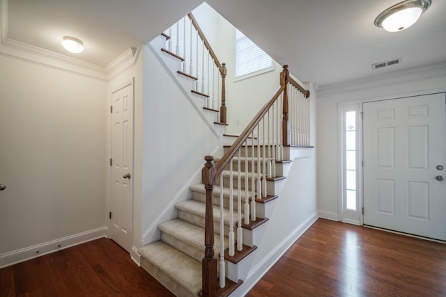 entryway featuring crown molding and dark hardwood / wood-style floors