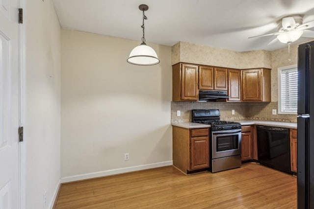 kitchen featuring dishwasher, hanging light fixtures, ventilation hood, gas range, and light wood-type flooring