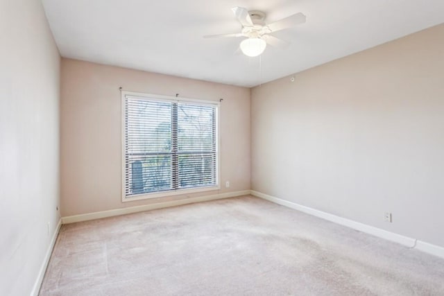 unfurnished room featuring light colored carpet and ceiling fan