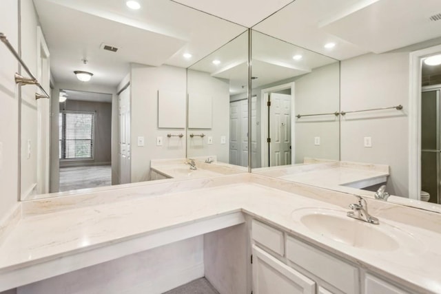 bathroom with vanity and toilet