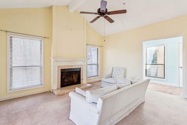 carpeted living room with ceiling fan, a fireplace, beam ceiling, and high vaulted ceiling