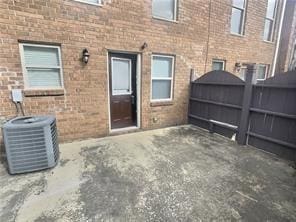 view of patio / terrace featuring cooling unit and fence