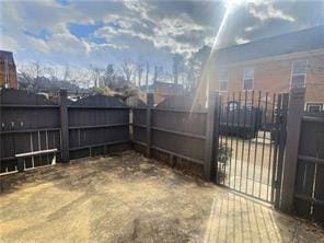 view of yard featuring a gate and a fenced backyard