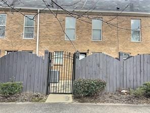 view of front of home with fence and a gate