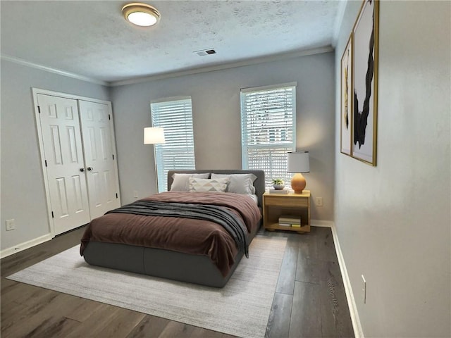 bedroom featuring visible vents, baseboards, and wood finished floors