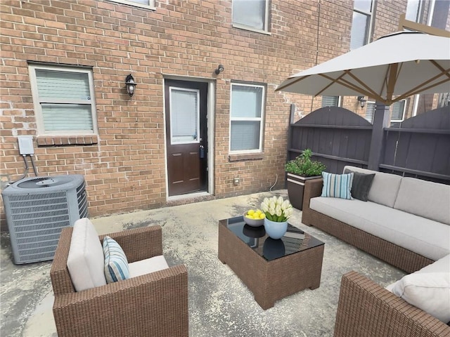 view of patio featuring cooling unit, an outdoor living space, and fence