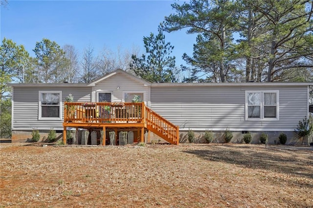 rear view of house featuring a deck