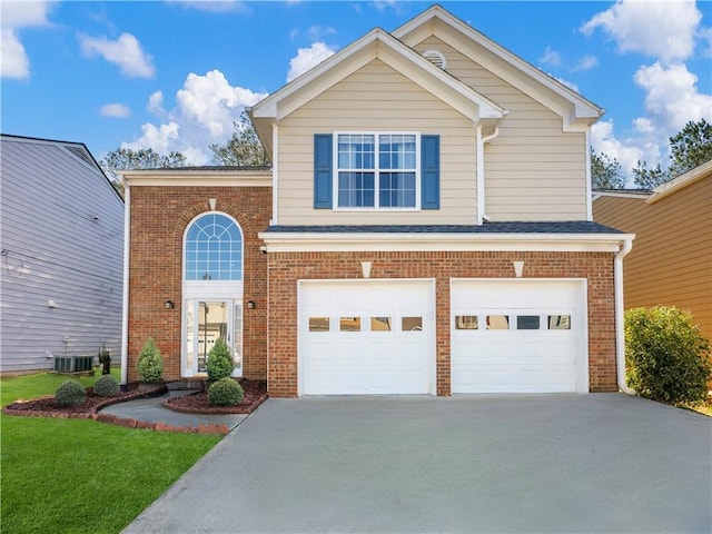 traditional-style home with a garage, concrete driveway, brick siding, and central AC