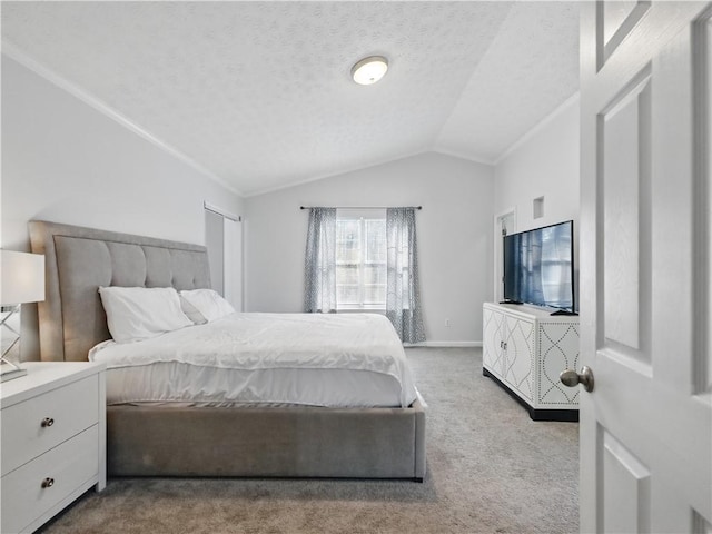 bedroom with carpet, baseboards, lofted ceiling, and a textured ceiling