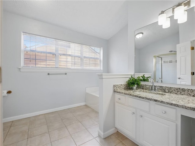 bathroom with lofted ceiling, tile patterned flooring, vanity, baseboards, and a bath