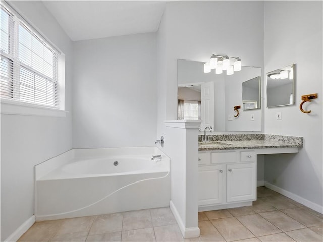 full bath featuring a healthy amount of sunlight, tile patterned flooring, a bath, and vanity