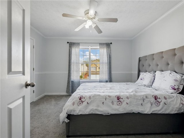 carpeted bedroom featuring ornamental molding, ceiling fan, a textured ceiling, and baseboards