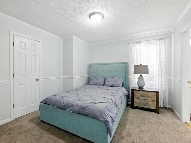 carpeted bedroom with a textured ceiling and crown molding