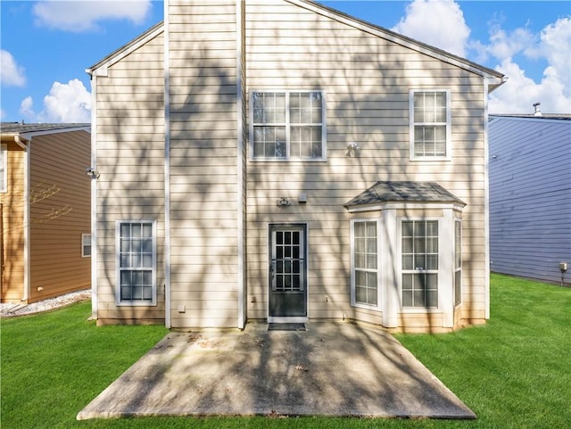 rear view of property featuring a patio area and a yard