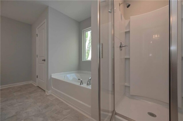 bathroom featuring separate shower and tub