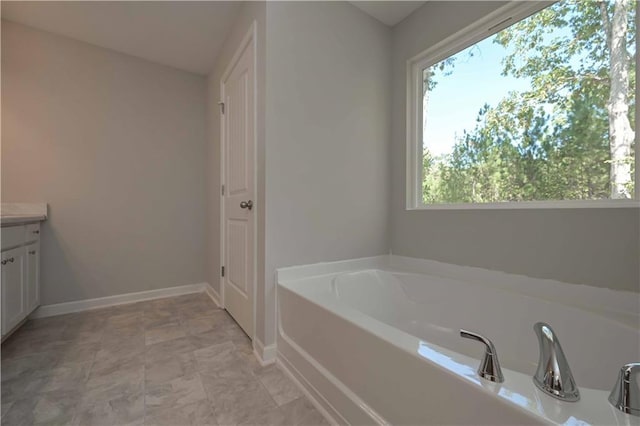 bathroom with a bathing tub and vanity