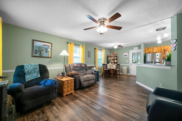 225 Hardin Rd SW, Plainville, GA 30733 - living area with a ceiling fan, dark wood finished floors, a textured ceiling, and baseboards