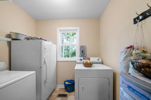 225 Hardin Rd SW, Plainville, GA 30733 - laundry room with separate washer and dryer, baseboards, and a textured ceiling