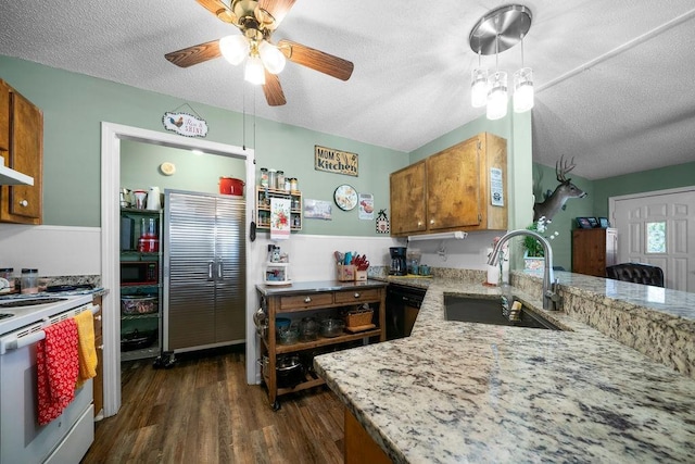 225 Hardin Rd SW, Plainville, GA 30733 - kitchen with a sink, white range with electric cooktop, ceiling fan, brown cabinets, and black microwave