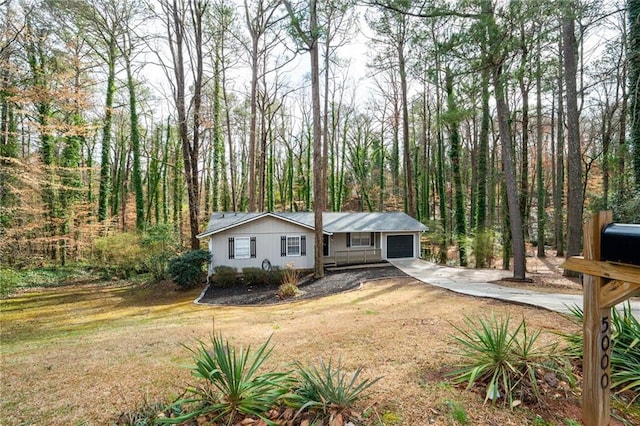 view of front of house with driveway, a front yard, and an attached garage