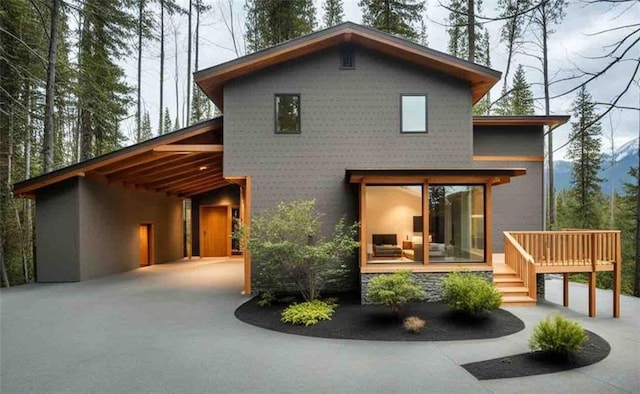 exterior space with a wooden deck and a carport