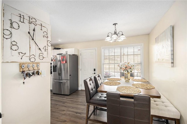 dining room with a chandelier and dark wood-type flooring
