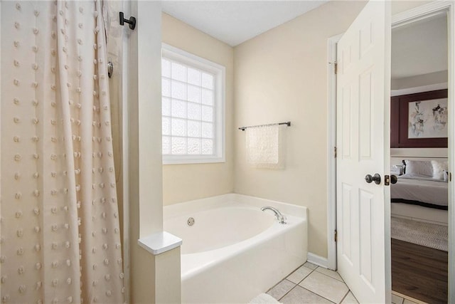 bathroom with tile patterned flooring, a shower with shower curtain, ensuite bath, and a bath