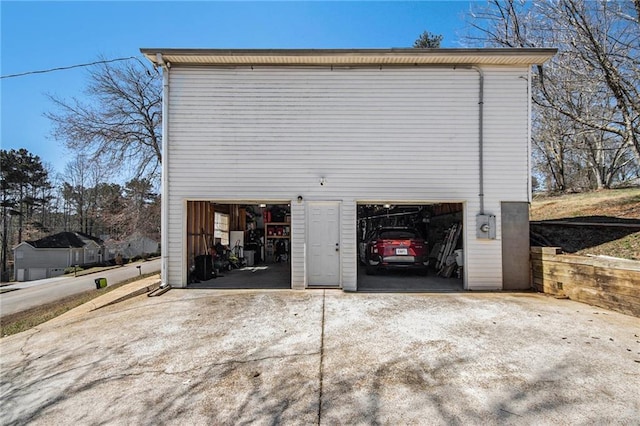 garage featuring concrete driveway