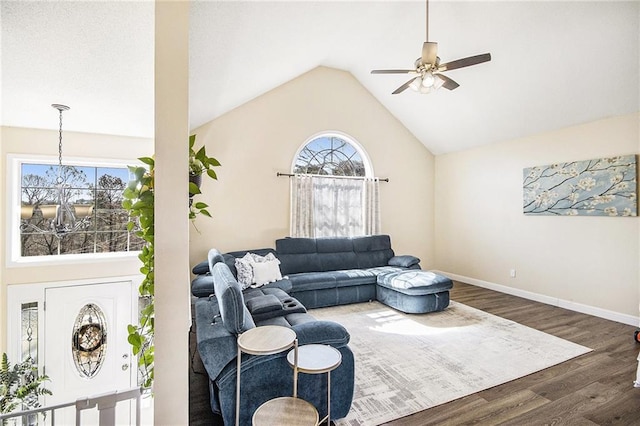 living area with a ceiling fan, baseboards, high vaulted ceiling, and wood finished floors