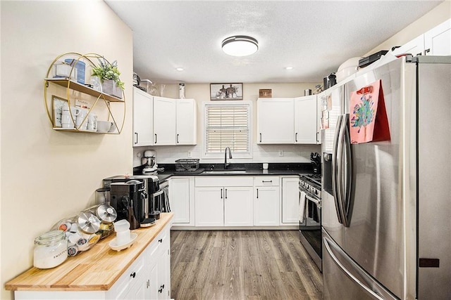 kitchen with white cabinetry, appliances with stainless steel finishes, and a sink