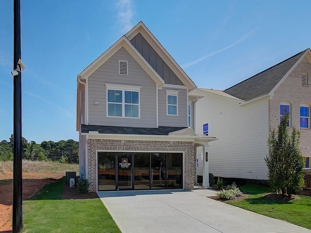 rear view of house with a garage and a lawn