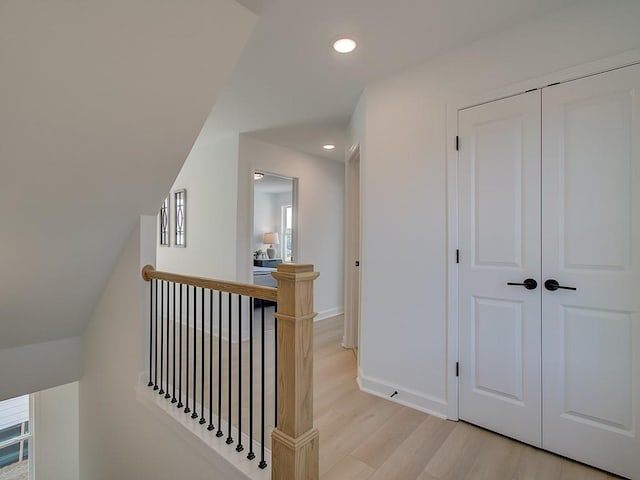 corridor with light hardwood / wood-style floors