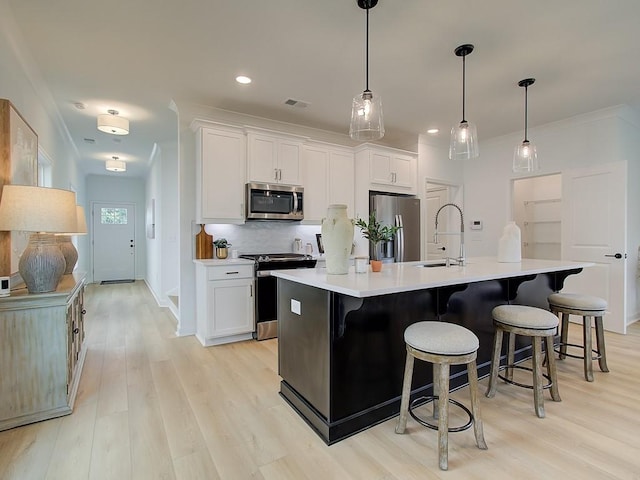 kitchen with white cabinetry, stainless steel appliances, a large island, and pendant lighting