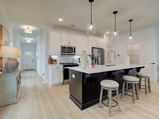 107 Winsome Way, Woodstock, GA 30188 - kitchen featuring a sink, light wood-style flooring, decorative backsplash, and stainless steel appliances