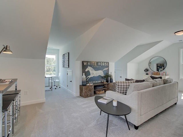 carpeted living room featuring lofted ceiling