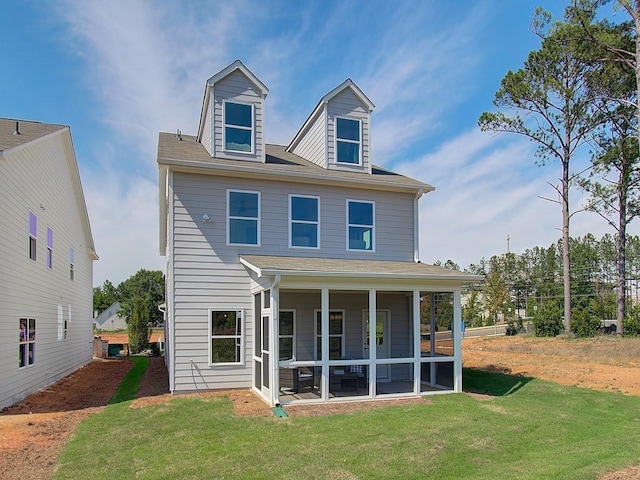 back of property featuring a sunroom and a yard