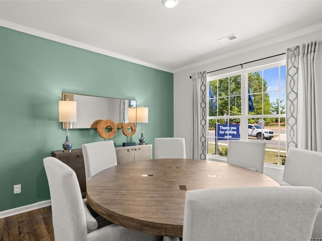 dining space featuring ornamental molding, visible vents, baseboards, and wood finished floors