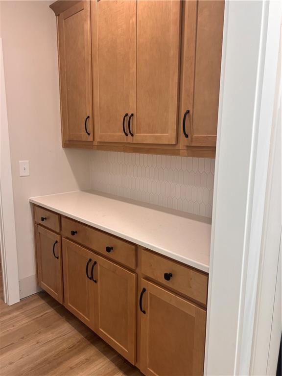 2719 Byess Ct, Marietta, GA 30064 - kitchen featuring light wood finished floors, light countertops, and tasteful backsplash
