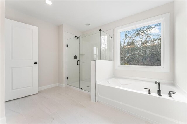 2719 Byess Ct, Marietta, GA 30064 - bathroom featuring a bath, a shower stall, marble look tiles, and recessed lighting