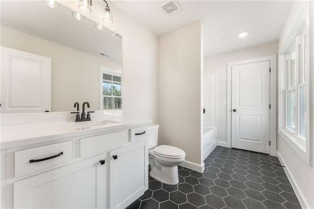 2719 Byess Ct, Marietta, GA 30064 - bathroom featuring toilet, a tub, vanity, baseboards, and recessed lighting