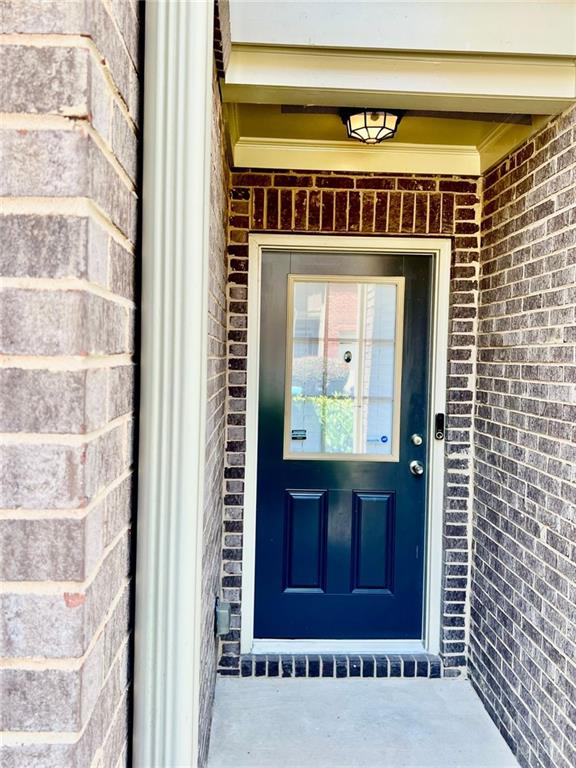 2691 Pointcrest Way, Grayson, GA 30017 - doorway to property with brick siding