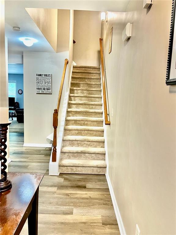 2691 Pointcrest Way, Grayson, GA 30017 - stairway with wood finished floors and baseboards