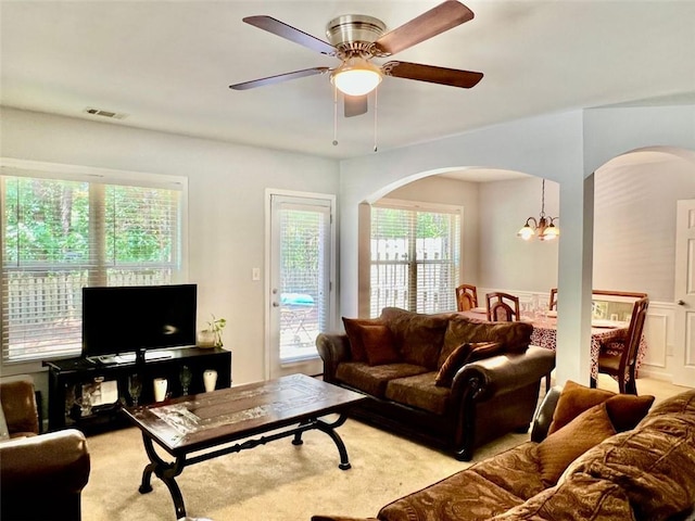2691 Pointcrest Way, Grayson, GA 30017 - living area with arched walkways, ceiling fan, and a chandelier