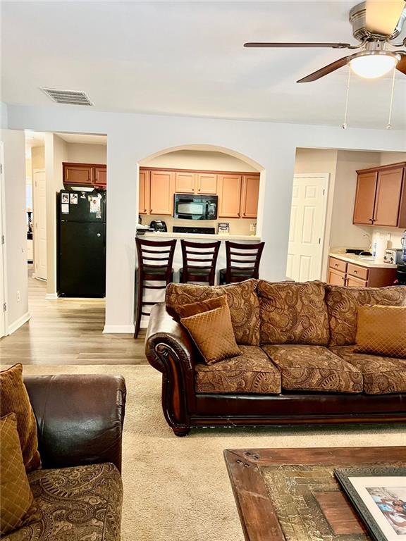 2691 Pointcrest Way, Grayson, GA 30017 - living area with arched walkways and a ceiling fan