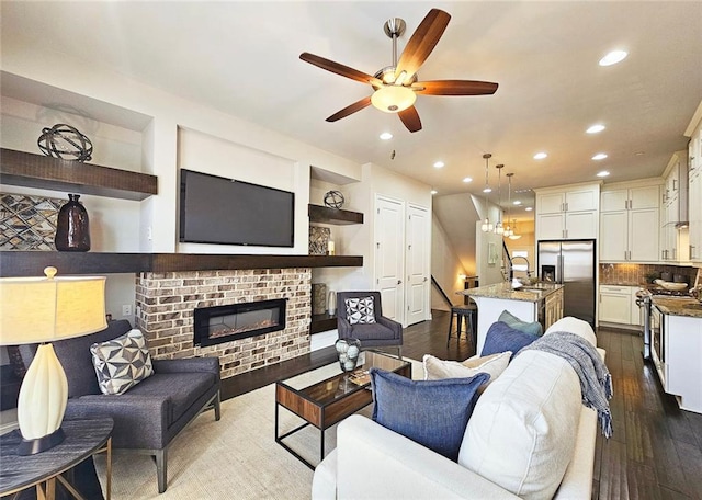 4107 Township Pkwy Unit 69, Sandy Springs, GA 30342 - living room featuring a ceiling fan, recessed lighting, dark wood-style flooring, and a fireplace