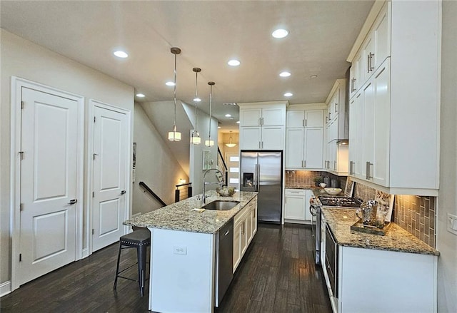 4107 Township Pkwy Unit 69, Sandy Springs, GA 30342 - kitchen featuring appliances with stainless steel finishes, dark wood-type flooring, recessed lighting, stone counters, and white cabinets