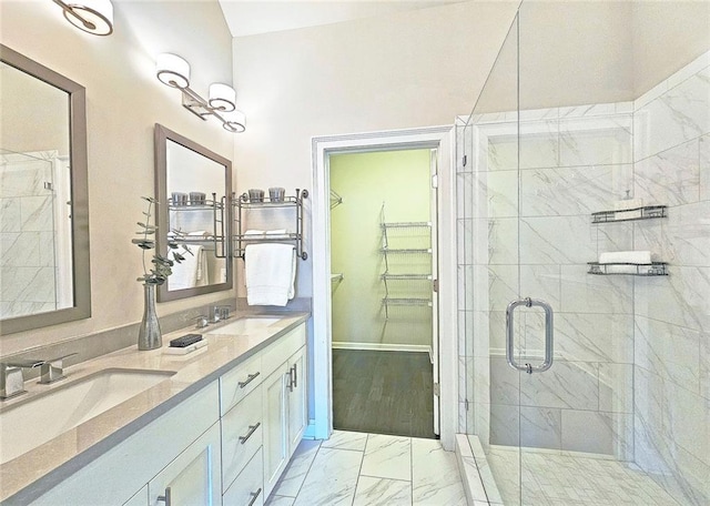 4107 Township Pkwy Unit 69, Sandy Springs, GA 30342 - bathroom with marble look tile flooring, a walk in closet, a stall shower, and double vanity