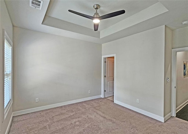 4107 Township Pkwy Unit 69, Sandy Springs, GA 30342 - unfurnished bedroom featuring a tray ceiling, carpet floors, and ceiling fan