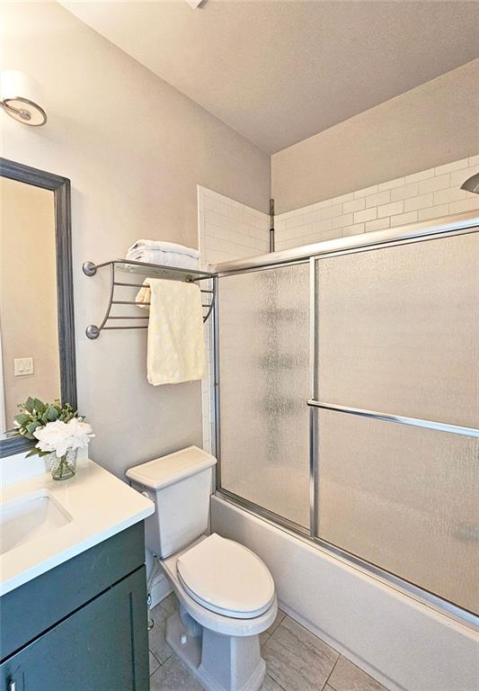 4107 Township Pkwy Unit 69, Sandy Springs, GA 30342 - full bath with vanity, bath / shower combo with glass door, and tile patterned floors
